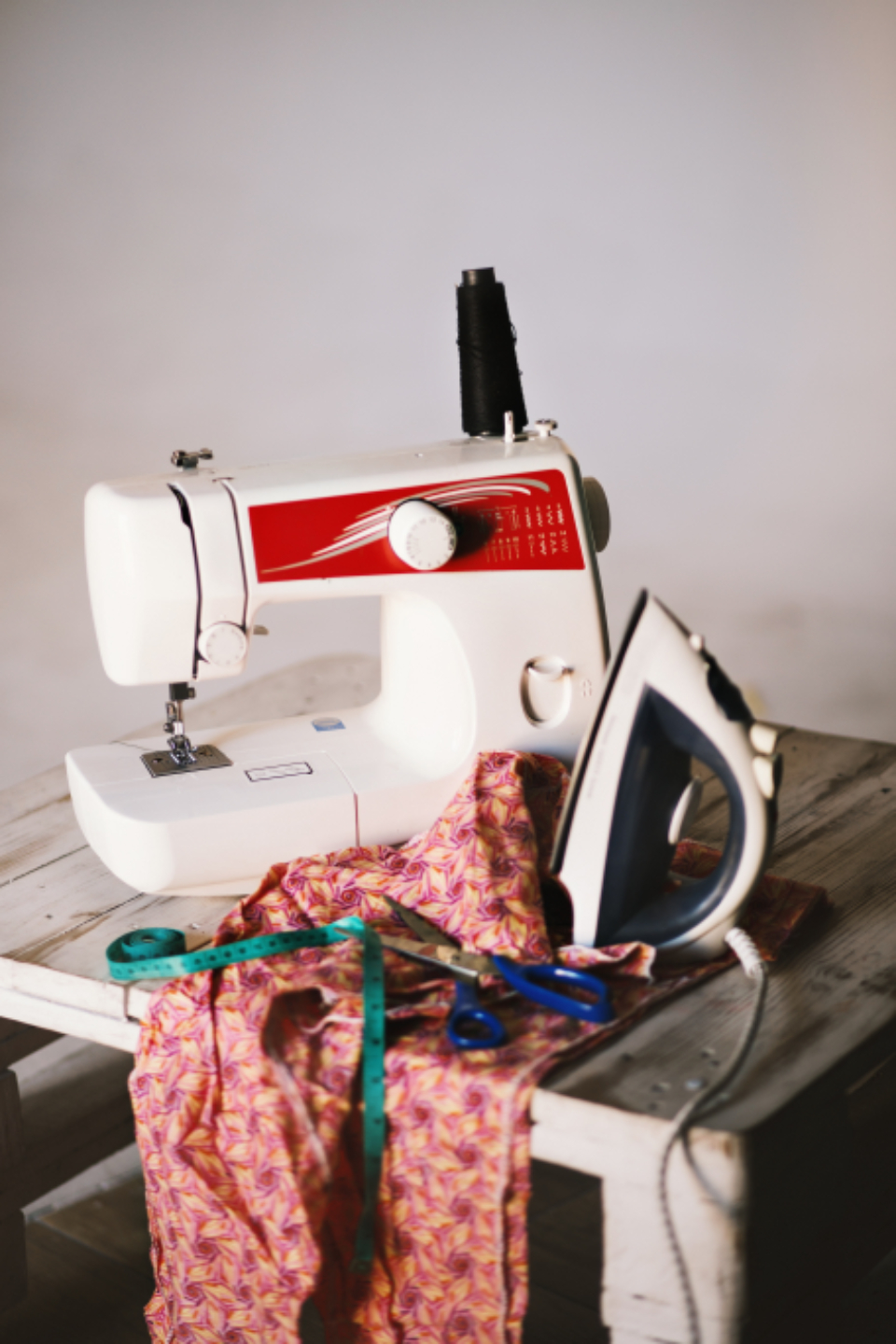 Sewing machine with fabric and tools on a table